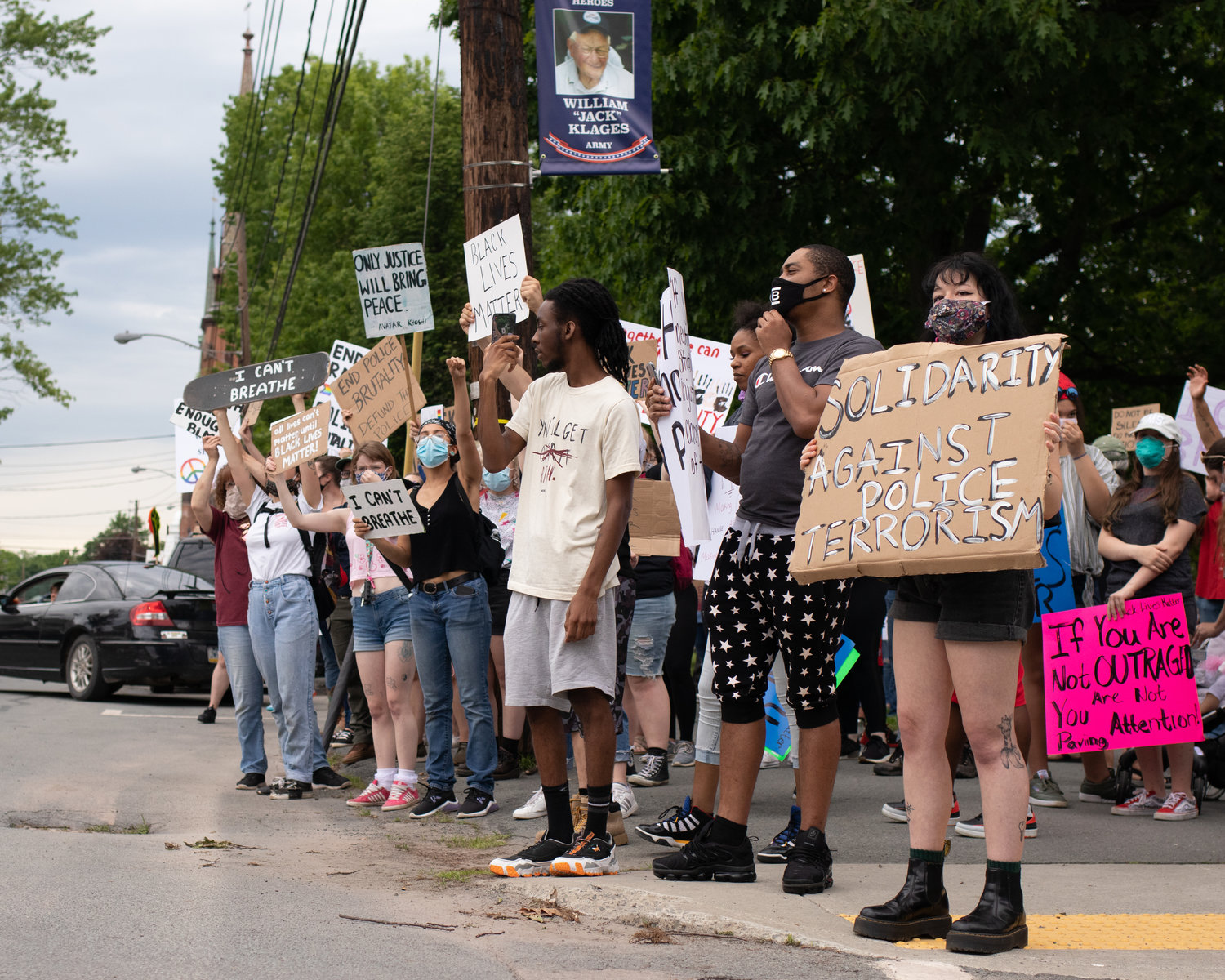A group of protestors stands at the edge of the Honesdale Central Park along Church Street in solidarity with the Black Lives Matter movement Thursday, June 4.
